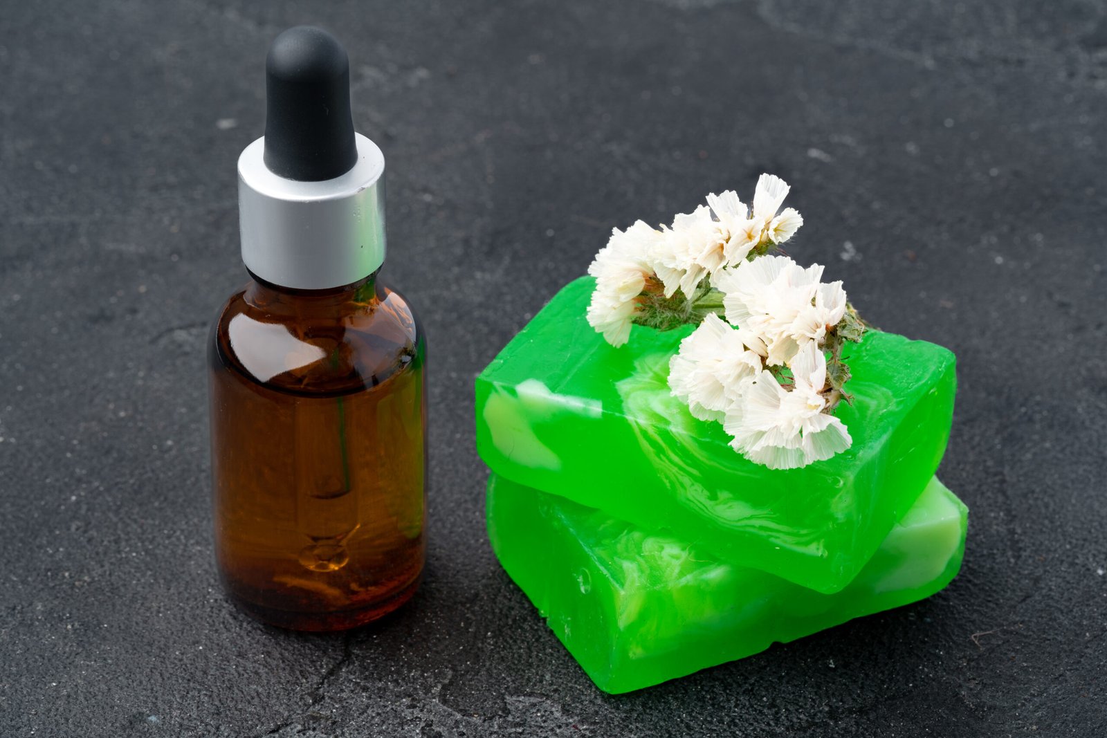 Skincare organic soap bars with plants extracts on gray surface, close up